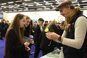 Madison Matravers and Leah Hadzik watch as David Billington from Reaseheath Horticultural department shows them the art of making a floral buttonhole