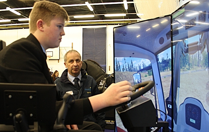 Careers - Mark Walton from Reaseheath Agricultural department watches James Brindley attentively as he tests his driving skills on the tractor simulator