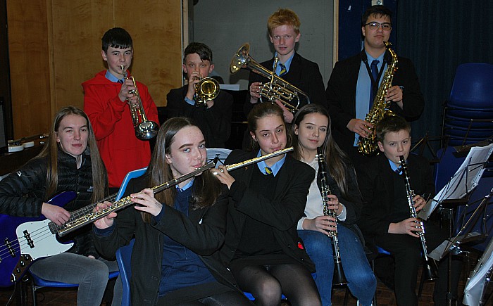 Members of the school band rehearse; they will play live at the theatre