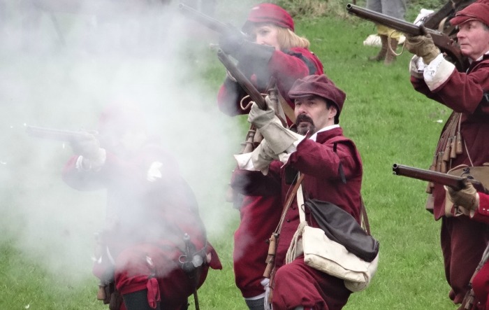 Muskets being fired on the battlefield