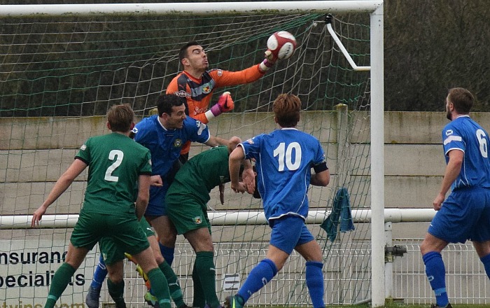 Nantwich goalkeeper Dan Gyollai punches the ball clear of danger v Barwell