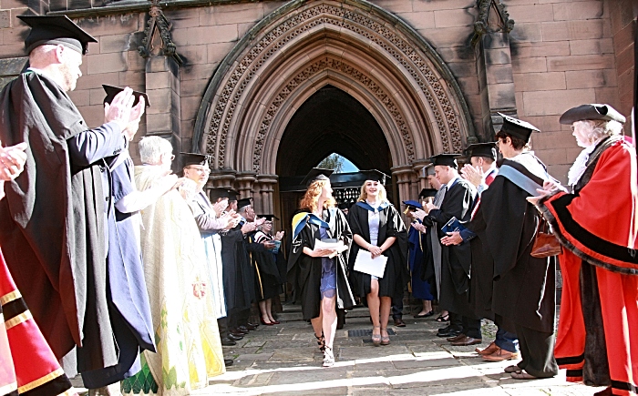 Graduates are congratulated by the procession party
