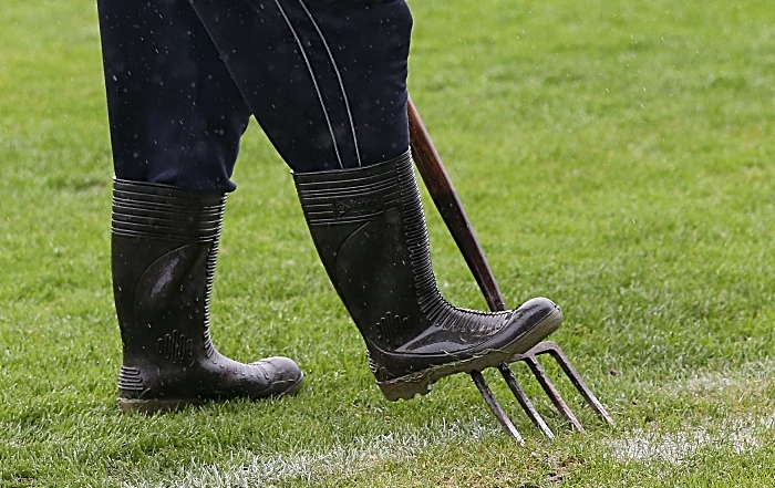 Pre-match - Nantwich Town groundsman helps drain surface water from the pitch (1)