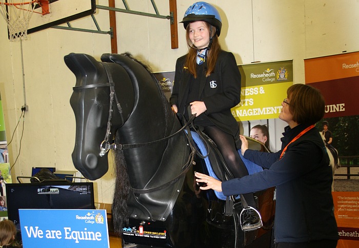 careers - Ruby Parsons gets the chance to 'experience' horse riding watched over by Dawn Joyce a member of the Reaseheath College Equine Staff