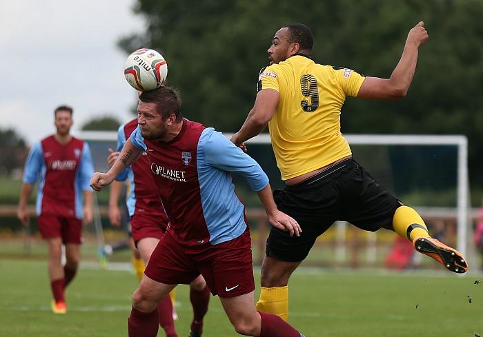 Sandbach player wins the ball from Clayton McDonald