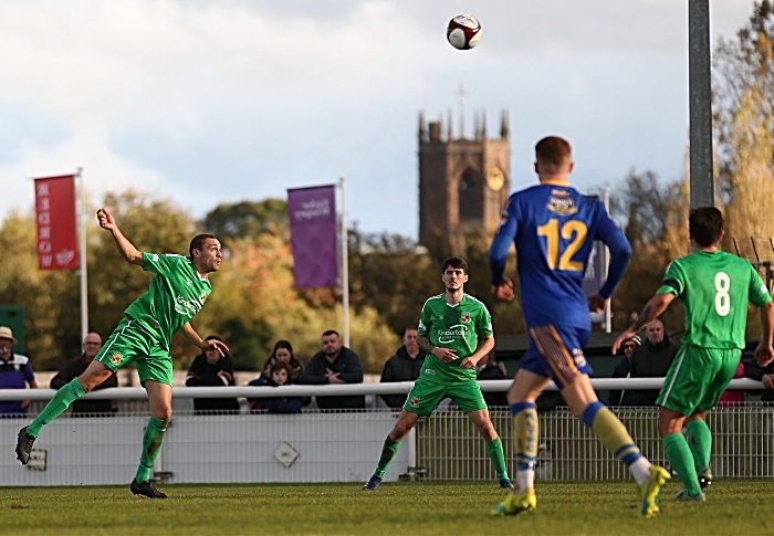 Second-half - Joe Stair heads the ball forwards with St Mary's Church, Nantwich in the background (1)