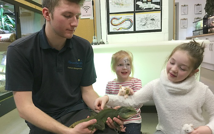 Sisters Francesca and Isabella Dalton from Northwich meet Chester the Asian water dragon and animal keeper Finn Holmes-Kellett