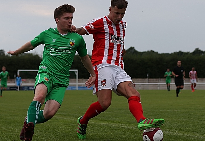 Stourbridge hold off a Nantwich player (1)