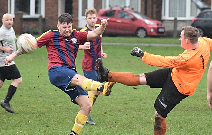 Talbot player challenges for the ball with the Salvador keeper (1)