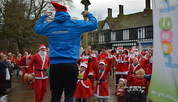 Total Fitness instructor Jamie warms up the participants - Santa Dash