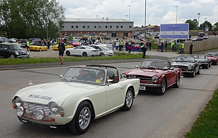 Vehicles leave Nantwich Football Club to follow their route