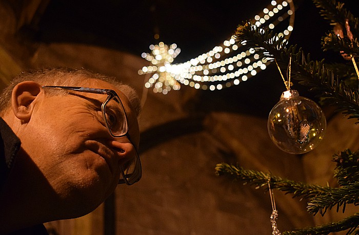 Visitor Mark Ray views a Christmas tree decoration