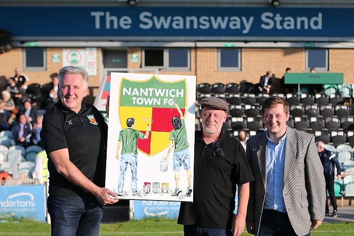 l-r Nantwich Town FC chairman Jon Gold receives artwork from Tony Denton and son Harvey (1)