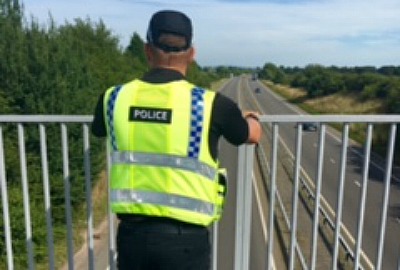 police on A500 foot bridge at Willaston