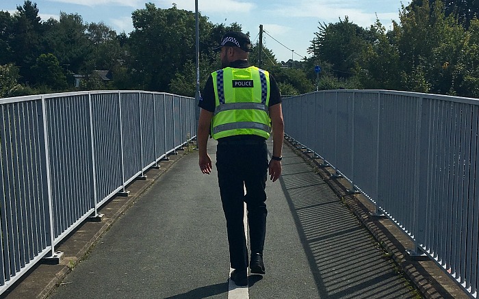police on foot bridge over A500 at Willaston